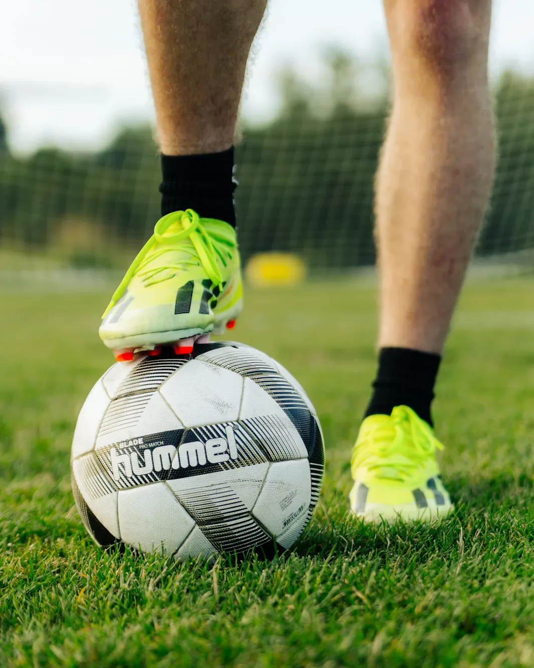 Footballer resting a foot on the ball